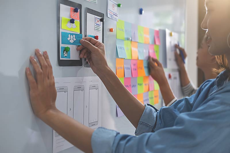 Women sticking sticky note